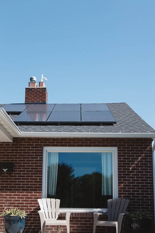 brick house with solar panel on the roof