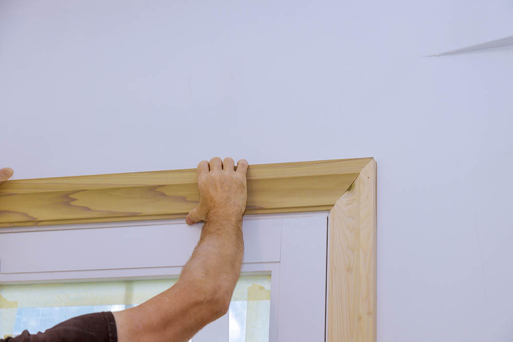 person installing door trim