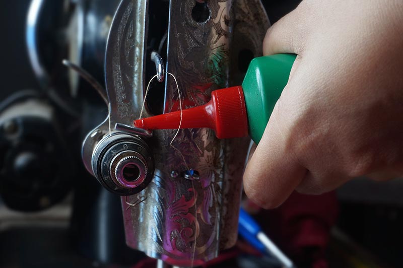 putting oil on sewing machine